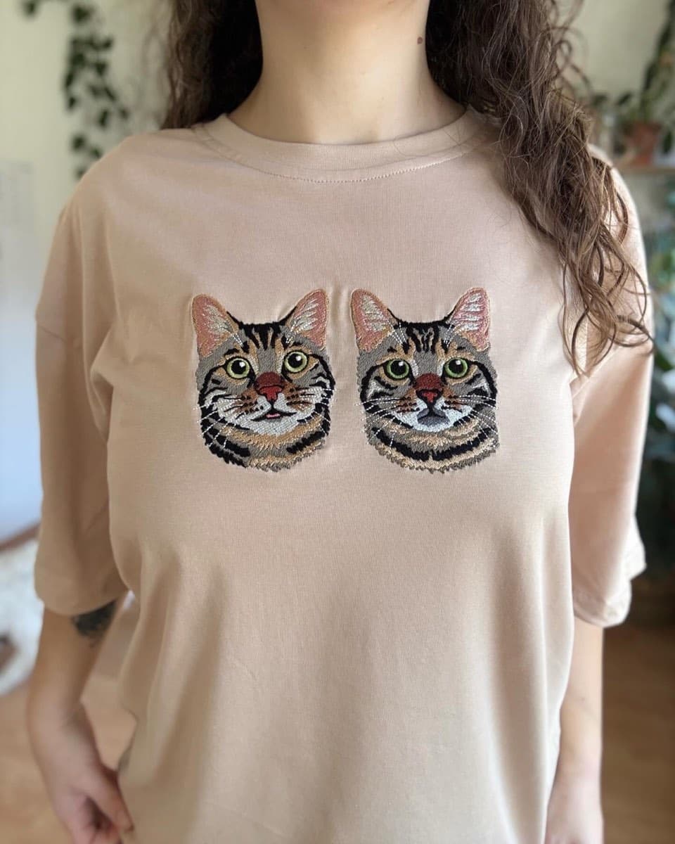 Krem rengi tişört üzerine işlenmiş iki kedi portresi nakışı